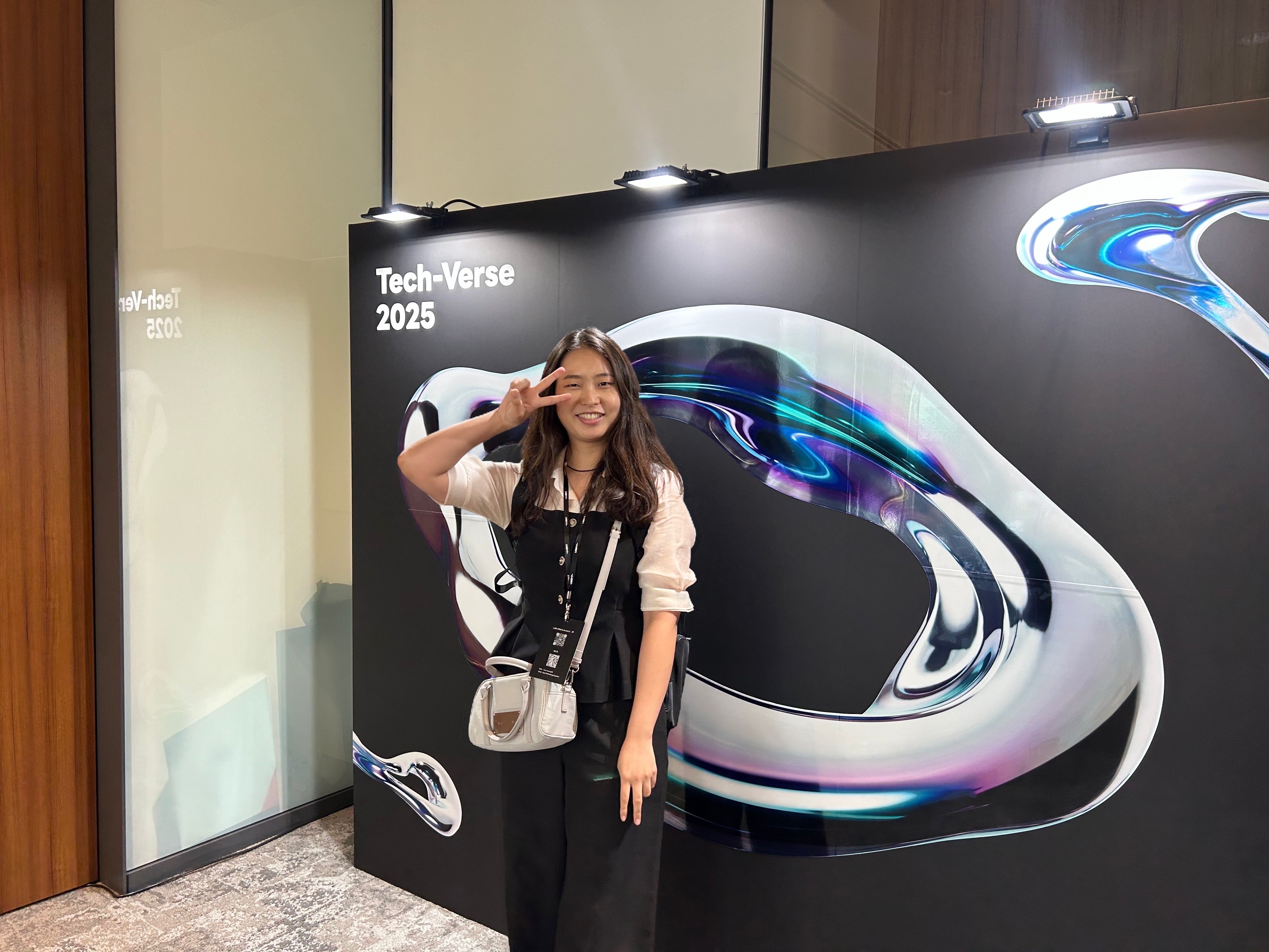 The Aurthor in front of Tech-Verse 2025 icon signboard